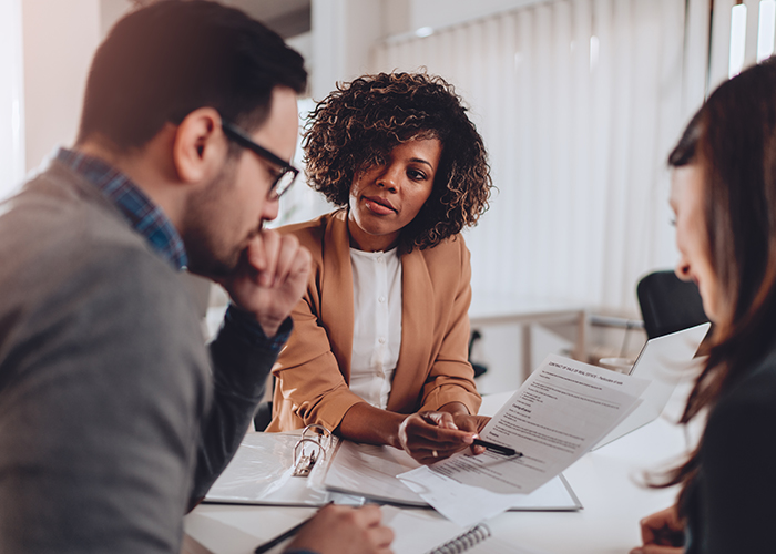 Couple preparing to sign a contract of sale and having second thoughts
