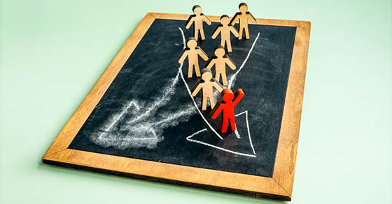 The figurine leads the crowd with changed direction.
