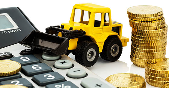 cost accounting in the construction industry and the construction industry. higher higher prices in road construction and in residential construction. excavator with coins and calculator