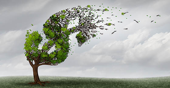 Financial trouble and money adversity or economic crisis concept as a tree being blown by the wind and damaged or destroyed by a storm as a business crisis metaphor with 3D illustration elements.