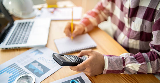 filled with Town planning,engineer people, architect man using calculator for accounting and analyzing building structure from blueprint,paper chart  with computer laptop at modern office workspace