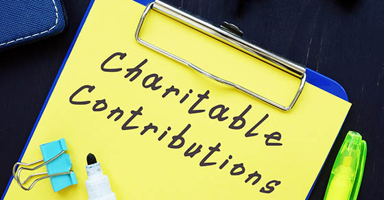 Business concept about Charitable Contributions with sign on the page.