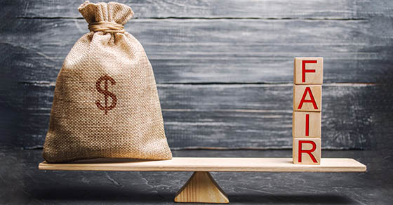 Money bag and wooden blocks with the word Fair. Balance. Fair value pricing, money debt. Fair deal. Reasonable price. Justified risk. Honest loan. Secured loans.