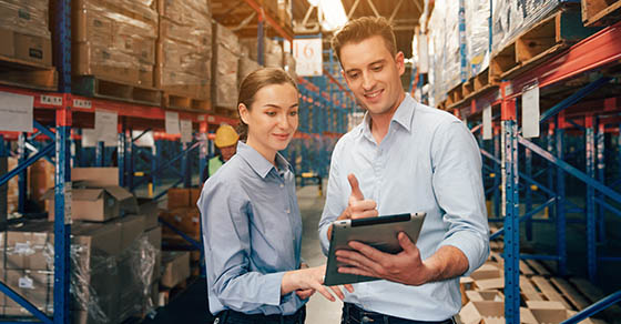 Warehouse manager talking and using digital tablet while checking product in warehouse, Logistic industry concept.