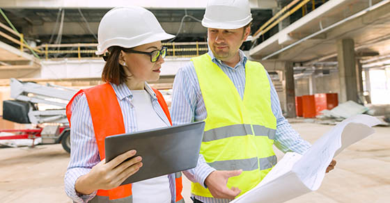 Two business builder people at construction site. Builder, inspector, engineer, architect, customer, people working at building