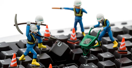 computer repair concept - workers repairing keyboard