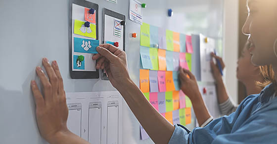 Creative Web Designer planning application and developing template layout, framework for mobile phone. User experience (UX) concept.