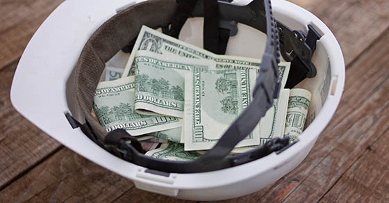 Money is in the white helmet of the worker