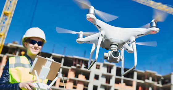 Drone operated by construction female worker on building site