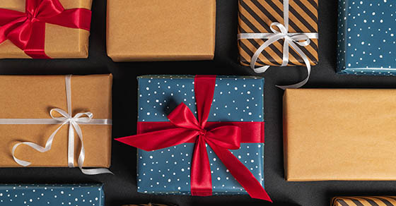 Christmas gift boxes with ribbon and bows on black background. High quality photo