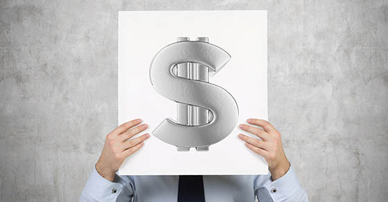 Young businessman holding a white placard with dollar sign.