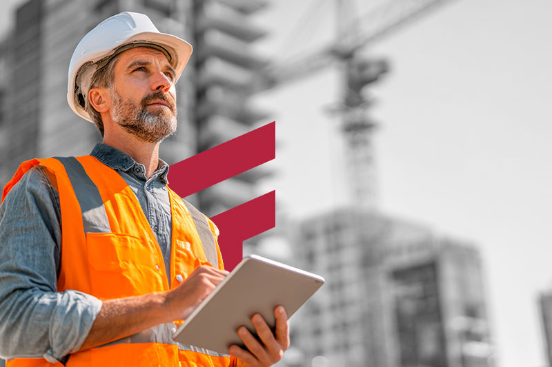 Construction foreman on the job site reviews accounting data